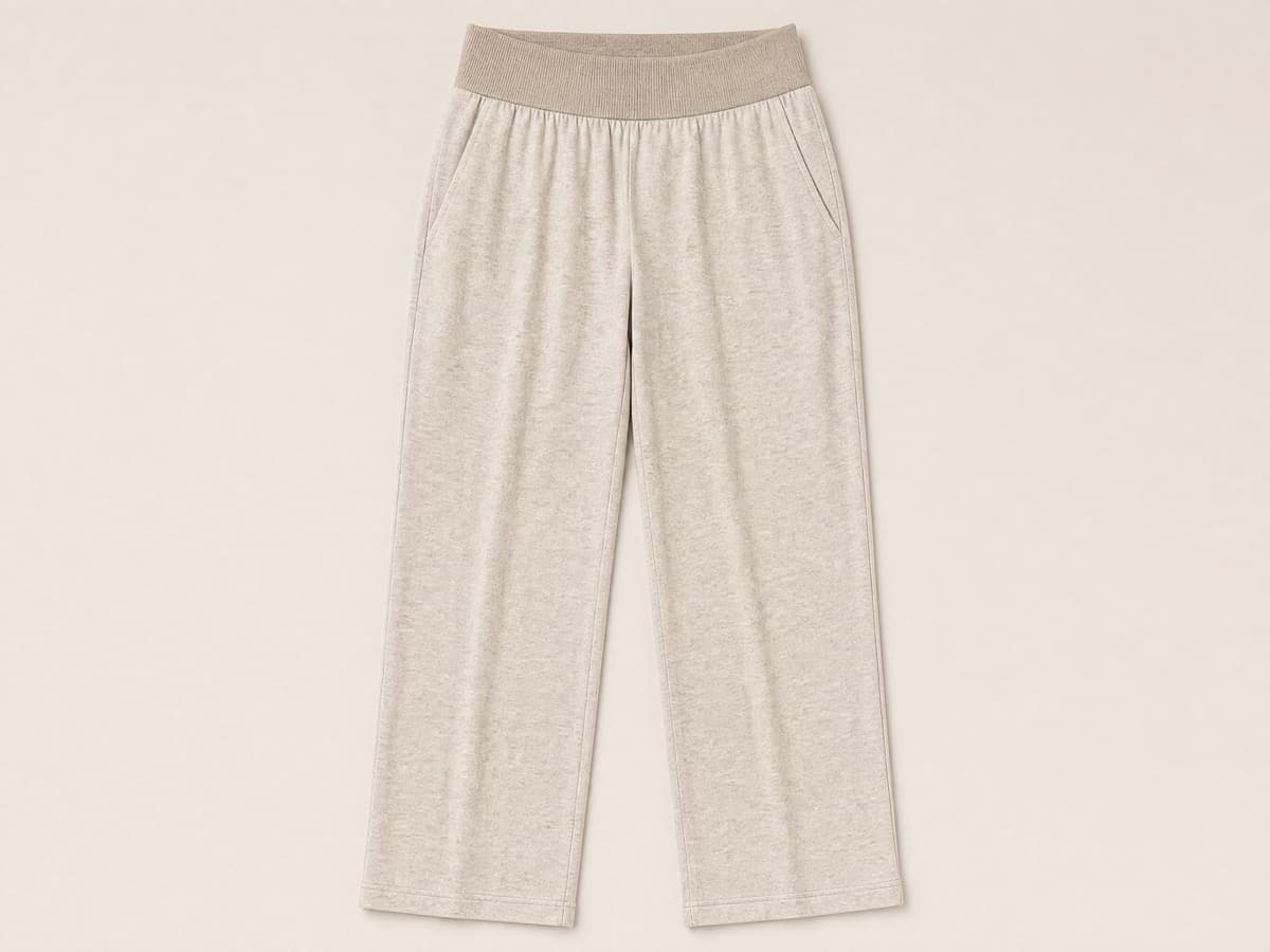 Oatmeal jersey trousers laid flat with a wide fully elasticated soft waistband, no button and no rigid waistband facing.
